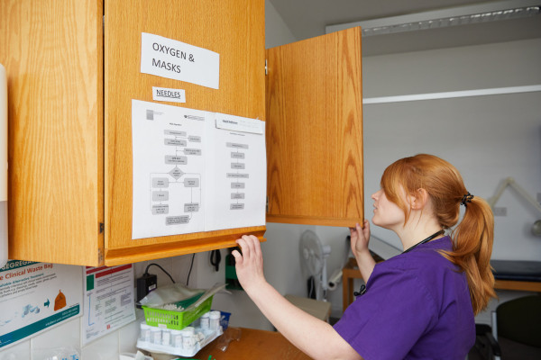 A photo showing Dr Callaghan getting something out of the emergency cupboard
