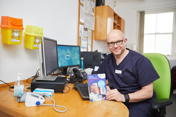 A photo showing Dr cottingham showing a leaflet