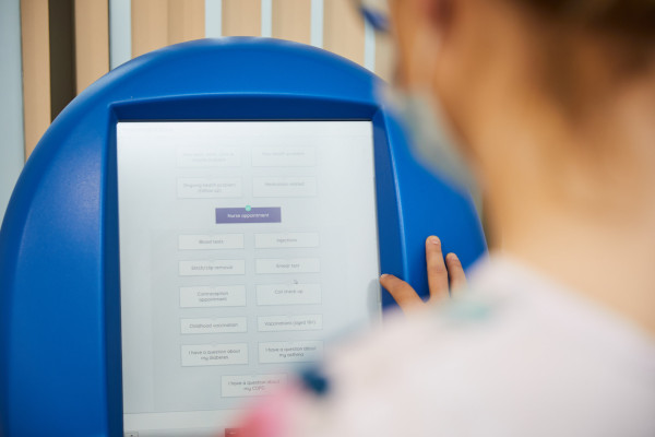 A photo showing the prioryCARE form on a computer in the reception areas