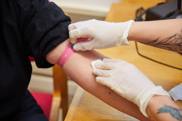 A photo showing a patient having their blood taken